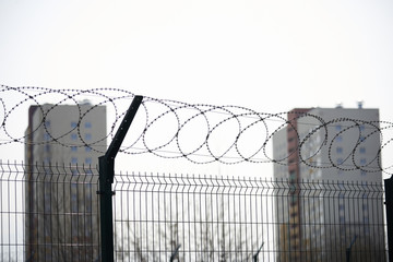 Residential buildings and a kindergarten surrounded by barbed wire