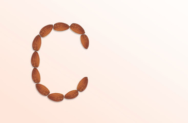 Letter C of the English alphabet from nuts. Food pattern made from nuts alphabet for shop and diet