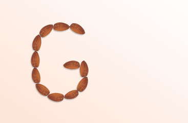 Letter G of the English alphabet from nuts. Food pattern made from nuts alphabet for shop and diet