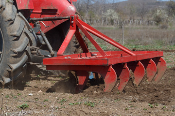 Farmer Cultivating Orchard Using Tractor
