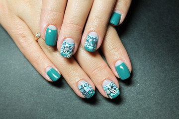 Summer bright moon manicure with marine design colored gel paint drawn by hand the hands of a fashionable modern woman