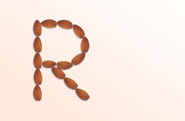 Letter R of the English alphabet from nuts. Food pattern made from nuts alphabet for shop and diet