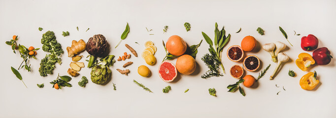 Variety of immunity boosting plant foods. Flat-lay of ginger, turmeric, kale, artichoke, citrus...