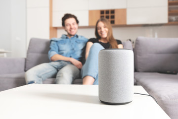 Couple talking command to smart speaker