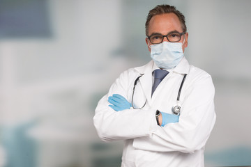 relaxed doctor with medical face mask and medical gloves