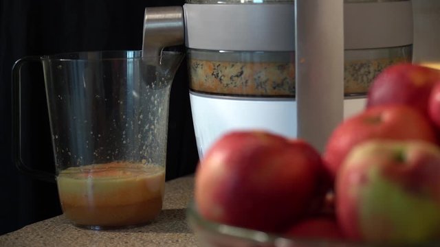 taking an apple and squeezing juice
