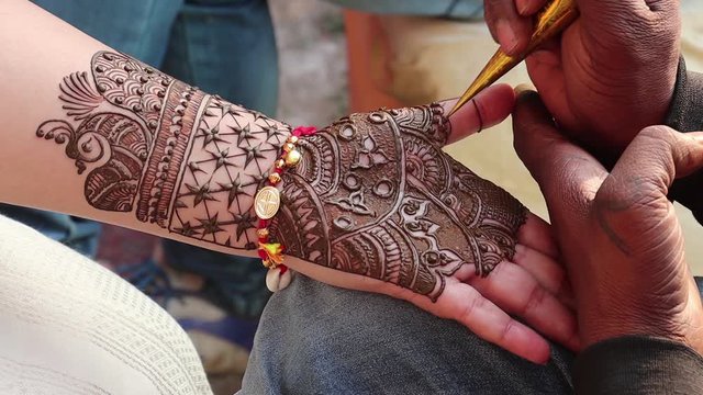 Stunning traditional Indian temporary tattoo realized with henna paste during the Mehndi ceremony. Hindu wedding traditions and rituals. Agra, Uttar Pradesh, India.