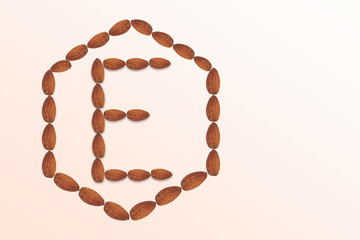 Letter E of the English alphabet from nuts in hexagon shape. Food pattern made from nuts alphabet for shop and diet
