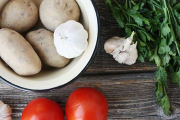 Tomatoes potatoes and garlic on the table