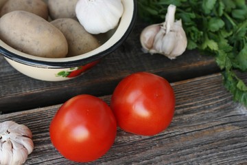 Tomatoes potatoes and garlic on the table