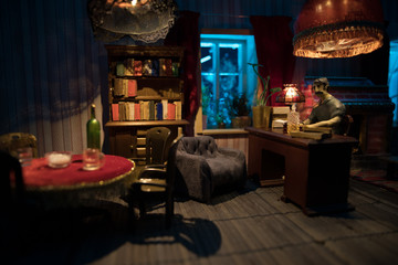 A realistic dollhouse living room with furniture and window at night. Artwork table decoration with handmade realistic dollhouse.