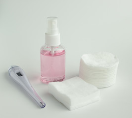 Protecting health from bacteria and viruses. Hand sanitizer, face mask and body thermometer.