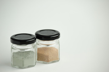 Cosmetic clay in glass containers for skin care. Pink and blue cosmetic clay.