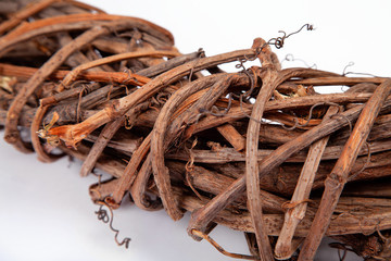 Braided vine wreath close-up. Texture and background image on a white background. Handmade from natural material.