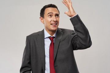 young businessman with arms raised