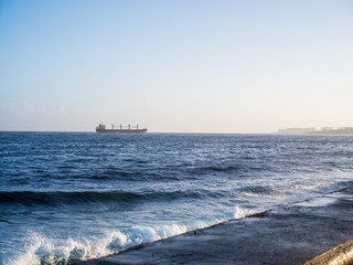 Cargo ship in the horizon arriving in Havana, cuba