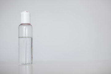 hand hygiene or disinfection concept - bottle of sanitizer gel or disinfectant over white