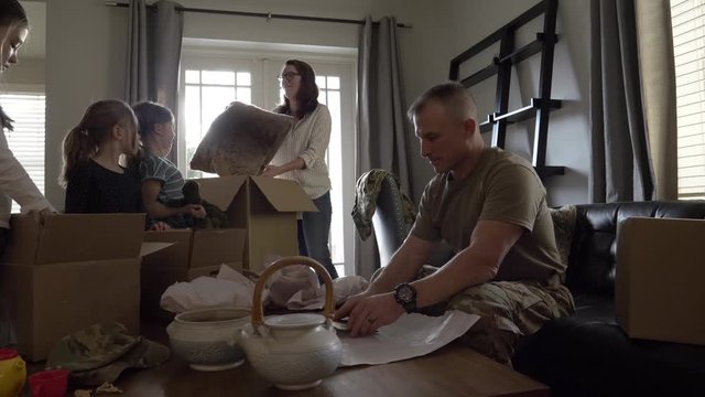 Military Family Packing Belongings To Move House