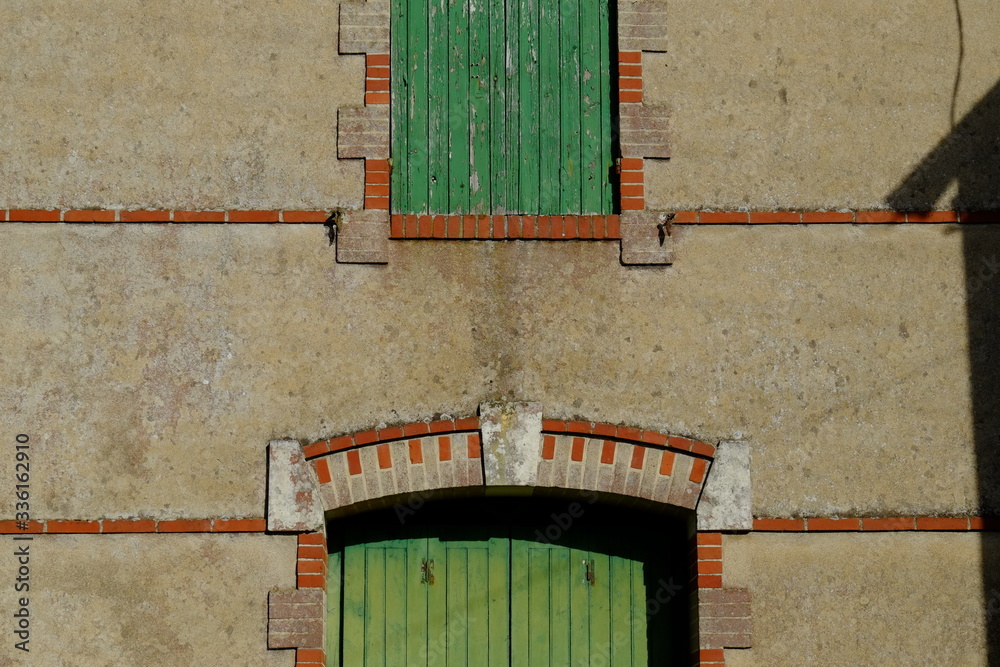 Wall mural Some closed and old shutters in a french city near the sea.