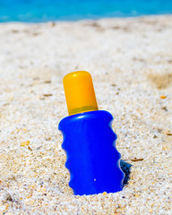 Fototapeta na wymiar Close up of a blue and yellow suntan bottle