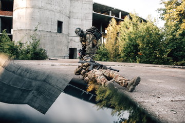 Military soldier drags teammate wounded from bullets by the scruff of the ground