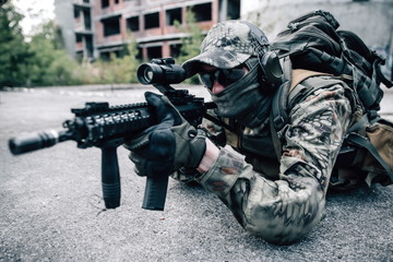 Camouflaged sniper aiming at enemy