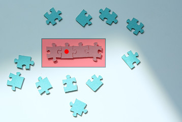 On a white background blue puzzles. Some of them are in the red zone