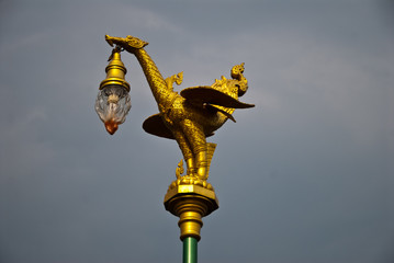 Fototapeta na wymiar Lamp in the form of a dragon on a pole