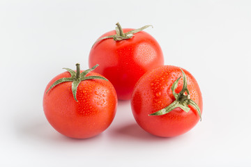 Beautiful juicy red tomatoes on a white background