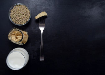 healthy eating. soy products soy tofu leather soy milk in glass jars and a glass on a dark slate background with place for text. Asian cuisine veganism. lean foods.