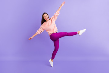 Fototapeta na wymiar Full size profile photo of funny lady rejoicing spend lovely time dancing youth party raise arms leg wear casual fur fuzzy sweater pants sneakers isolated purple color background