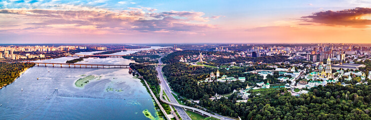 Obraz premium Sunset above the Dnieper River and Kiev Pechersk Lavra in Kyiv. UNESCO world heritage in Ukraine