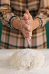 Woman prepares to her home handmade dough for bread, homemade cooking.