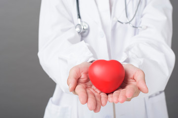 woman doctor is holding red heart