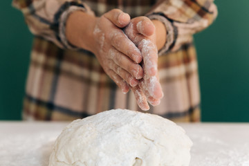 Woman prepares to her home handmade dough for bread, homemade cooking.