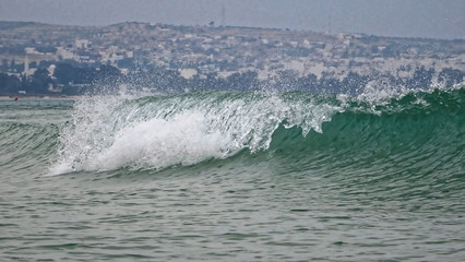 wave breaking into the water