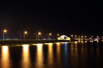 Fototapeta na wymiar The lights of the harbor water reflection at Sattahip, Chon Buri, Thailand