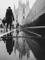 Milan Cathedral on a rainy day with reflection in the puddle