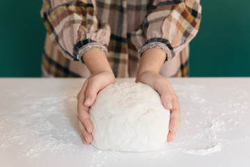 Woman prepares to her home handmade dough for bread, homemade cooking.
