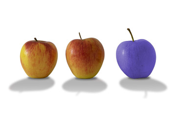 Blue apple close to normally apples isolated on white background