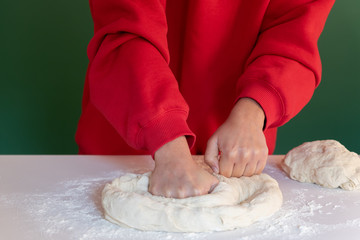 Woman prepares to her home handmade dough for bread, homemade cooking.