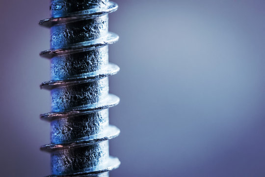 Part of screw with thread on grey background