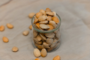 Bowl of  toasted almonds on a gray background