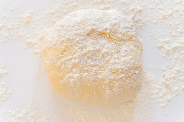 Fototapeta na wymiar Handmade dough for bread on a white marble background, homemade cooking.
