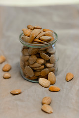 Bowl of  toasted almonds on a gray background