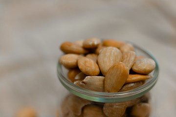 Bowl of  toasted almonds on a gray background