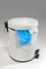 Littering the Medical mask into the garbage. Medical waste disposal.