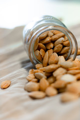 Bowl of  toasted almonds on a gray background