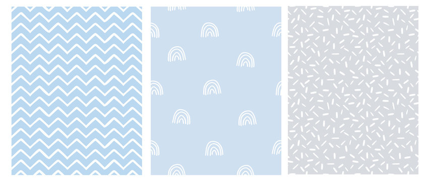 Abstract Hand Drawn Childish Style Seamless Vector Patterns. White Rainbows, Chevron and Stripes on a Gray and Blue Background. Simple Irregular Geometric Vector Prints. Pastel Color Design.