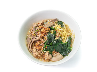 The close up of Thai Tom Yum Spicy Noodle with ivy gourd leaves on white bowl.